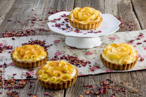 Rose apple tartalettes with rose petals with caramel glaze photo
