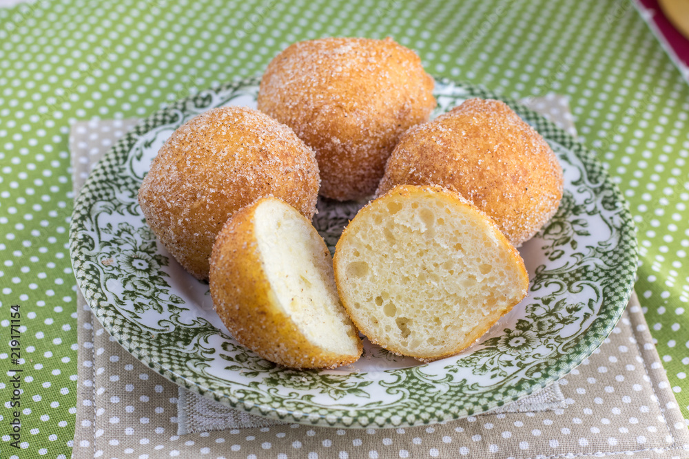 Cut fried curd donuts on a old plate
