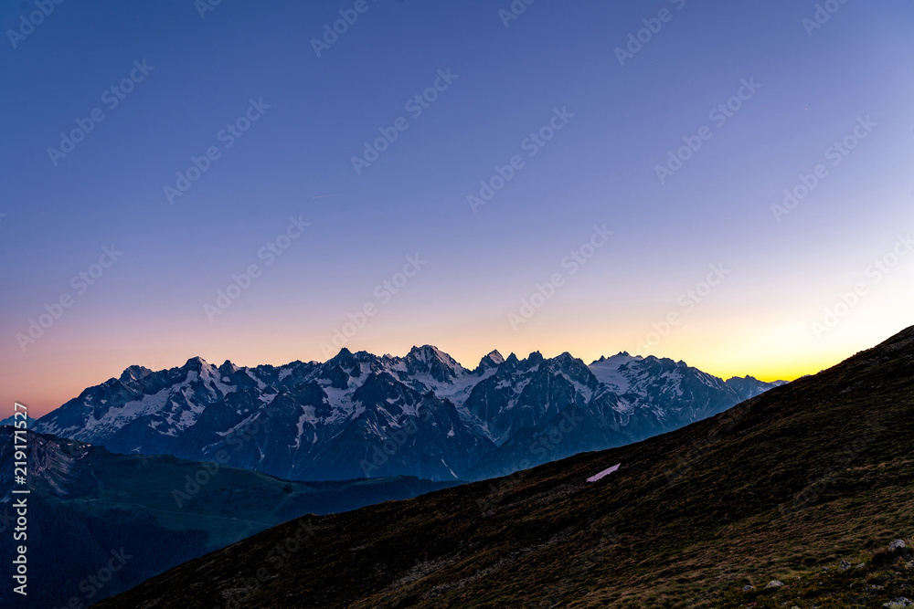 Scenic view of beautiful Swiss Alps mountains. Blue hour sunset with pink and blue tones, Verbier, Canton du Valais, Wallis, Switzerland.