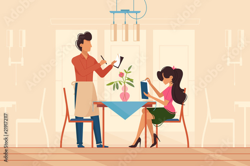 Girl makes order with waiter in restaurant