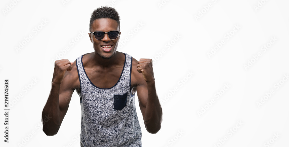 Young african american man screaming proud and celebrating victory and success very excited, cheering emotion Young african american man screaming proud and celebrating victory and success very excited, cheering emotion