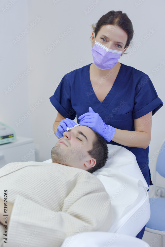 Young man on face treatment Young man on face treatment