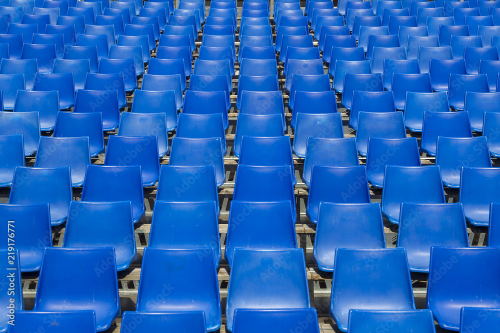 empty blue chair rows in a tribune empty blue chair rows in a tribune