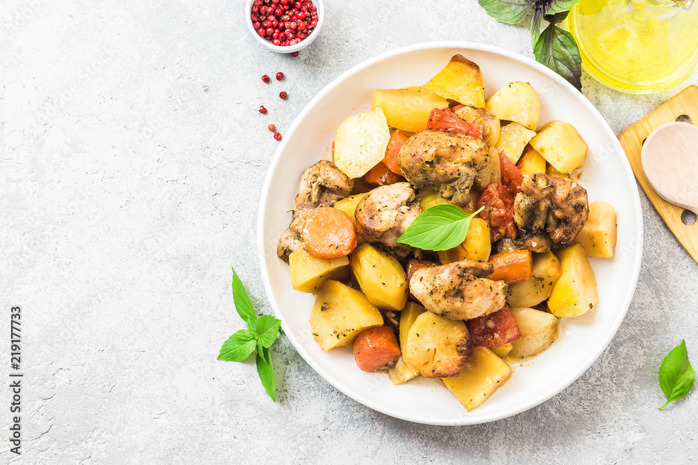 Roasted potato and carrot with lemon, garlic, spicy dressing. Top view, space for text. Roasted potato and carrot with lemon, garlic, spicy dressing. Top view, space for text.