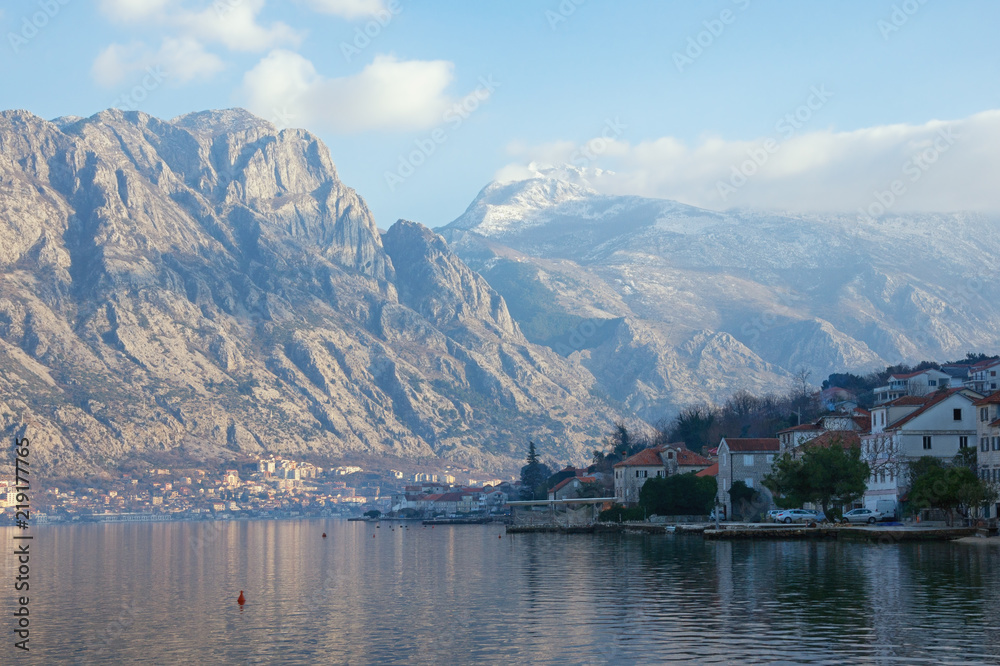 Beautiful winter Meditarranean landscape .  Montenegro,  view of the Bay of Kotor, the snow-capped mountain of Lovcen and the town of Prcanj