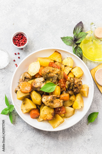 Roasted potato and carrot with lemon  garlic  spicy dressing. Top view  space for text.