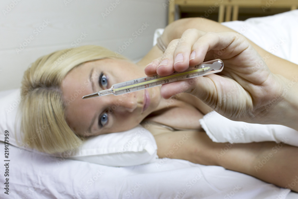 Young girl laying on the bed and feeling bad because the high fever. Young girl laying on the bed and feeling bad because the high fever.