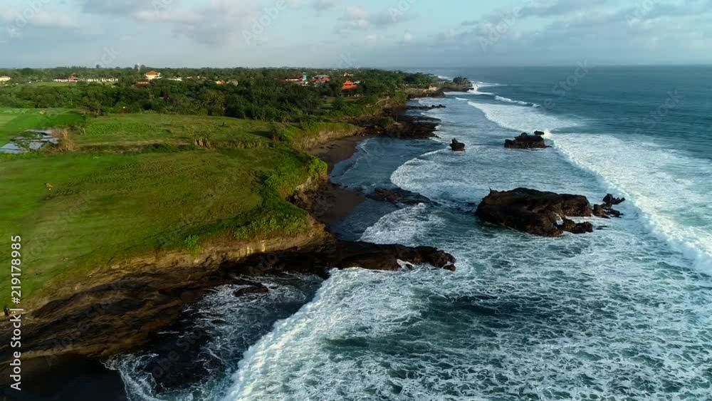 Sunset aerial view of the South-West coast of Bali, Indonesia. Tanah Lot Temple, Batu Bolong Temple.
