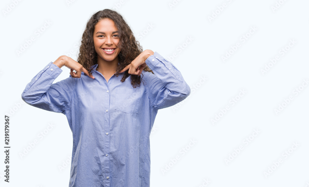 Young hispanic business woman looking confident with smile on face, pointing oneself with fingers proud and happy. Young hispanic business woman looking confident with smile on face, pointing oneself with fingers proud and happy.