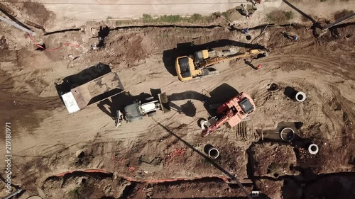 Aerial construction site with machinery, bulldozer, excavation. Top down view of city building site.