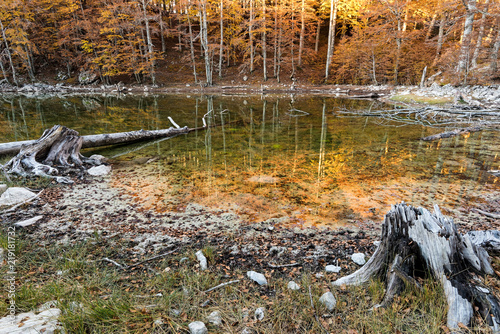 View of Arrenes or Moutsalia alpine lake on Mt Grammos in Greece during autumn at sunrise photo