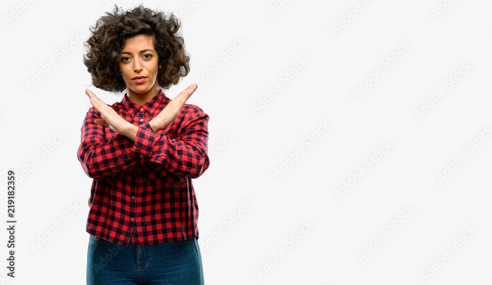 Beautiful arab woman annoyed with bad attitude making stop sign crossing hands, saying no, expressing security, defense or restriction Beautiful arab woman annoyed with bad attitude making stop sign crossing hands, saying no, expressing security, defense or restriction