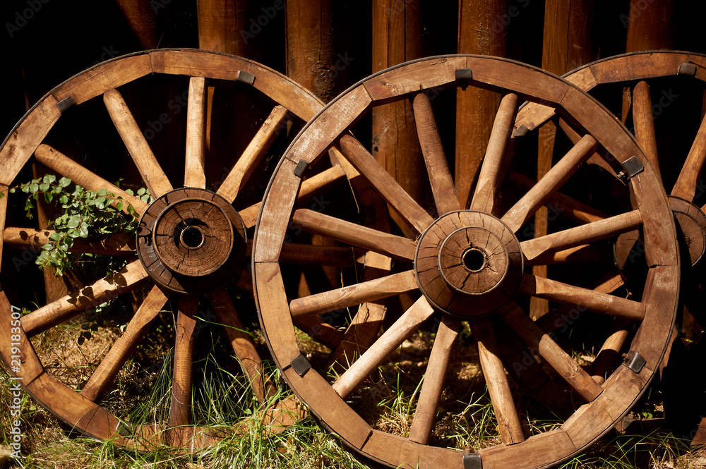 Old wooden wheels from the cart. Retro, country life. The first way to travel