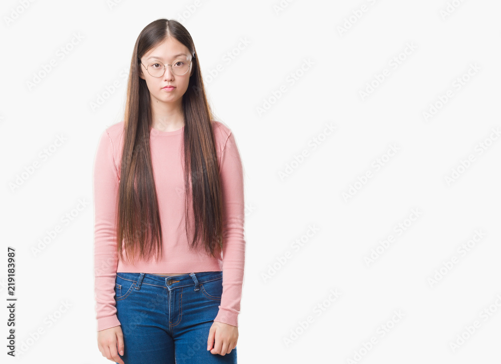 Young Chinese woman over isolated background wearing glasses with serious expression on face. Simple and natural looking at the camera. Young Chinese woman over isolated background wearing glasses with serious expression on face. Simple and natural looking at the camera.