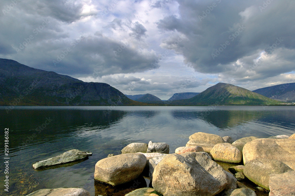 Dark gray clouds under lake in mountain