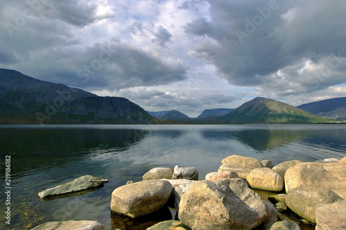 Dark gray clouds under lake in mountain