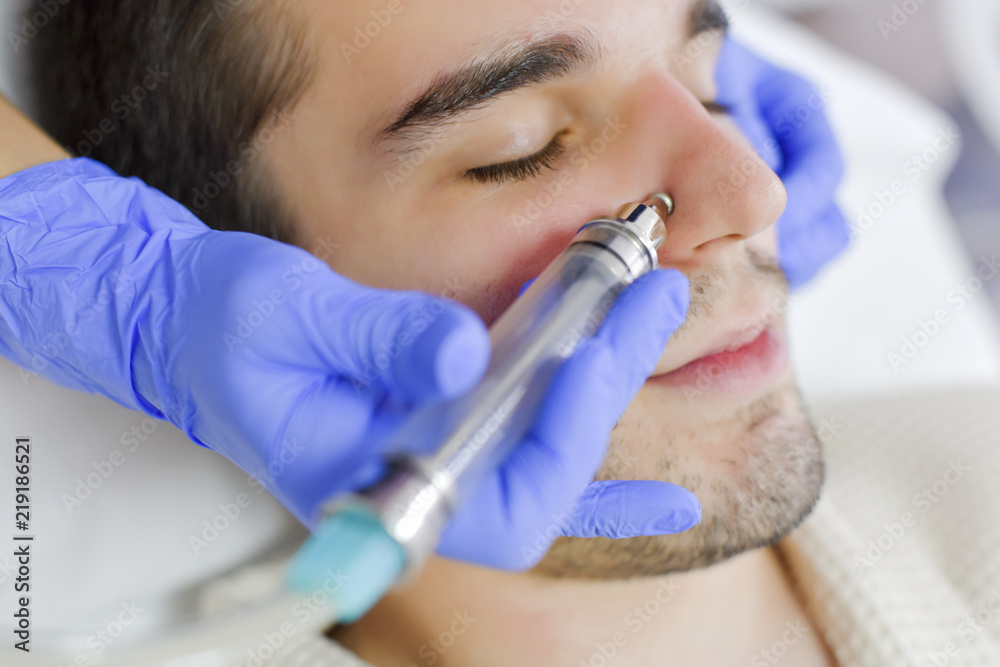 Young man on face treatment Young man on face treatment