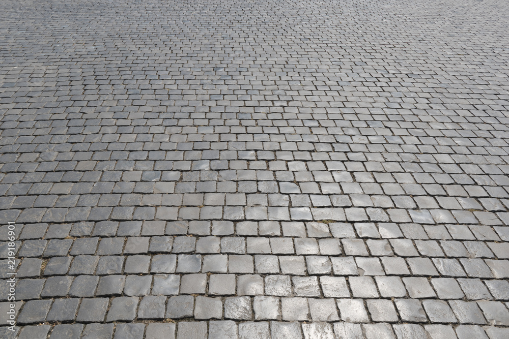 Old cobblestone pavement in perspective. Abstract background.