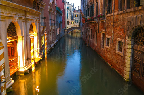 View on the historic architecture and the canal between the ancient buildings in Venice, Italy on a sunny day. © Spectral-Design