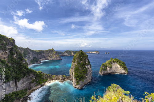 Blue sky over beautiful blue waters of the Raja Lima islands just off the coast of Nusa Penida, Indonesia. photo