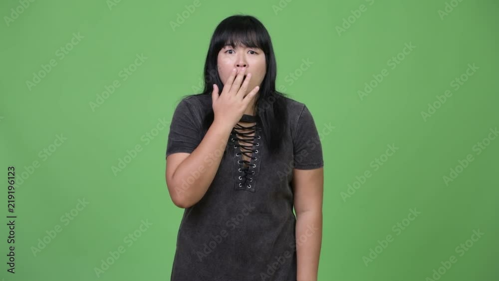 Beautiful overweight Asian woman looking shocked Beautiful overweight Asian woman looking shocked
