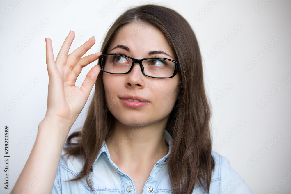 Eyeglasses for good vision, girl on white background with bad sight closeup