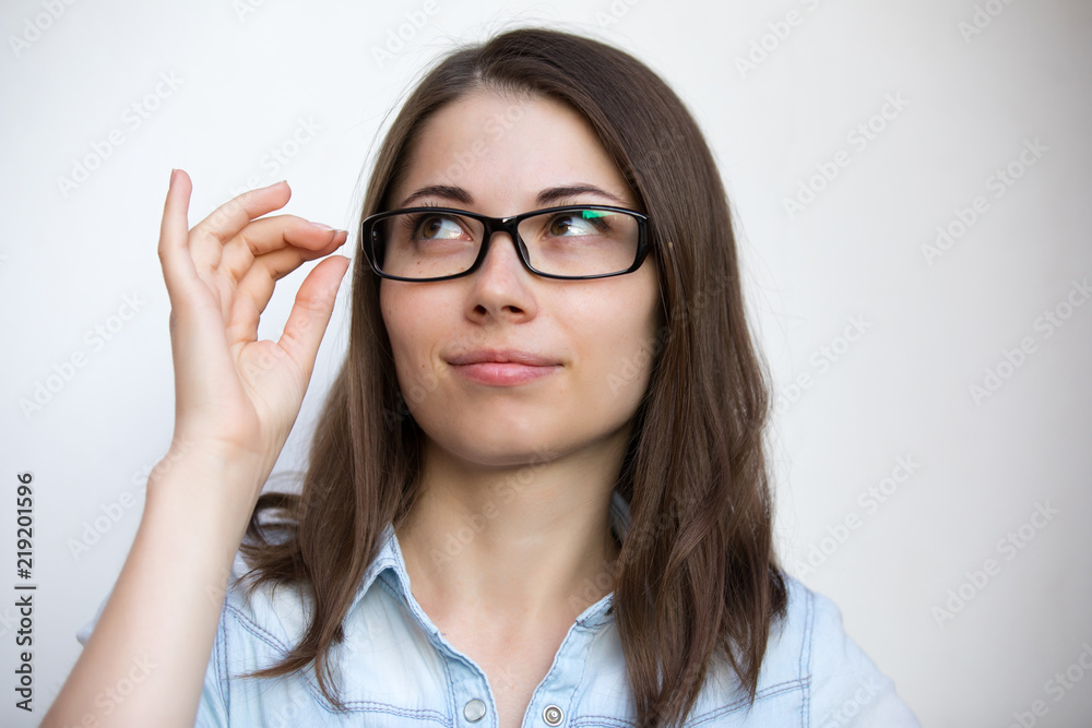 Eyeglasses for good vision, girl on white background with bad sight closeup
