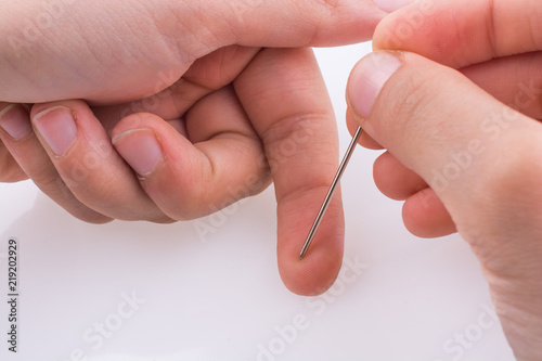 Hand holding a needle