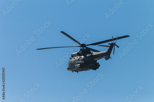 Fototapeta Naklejka Na Ścianę i Meble -  Helicopter Military Flying Blue Sky