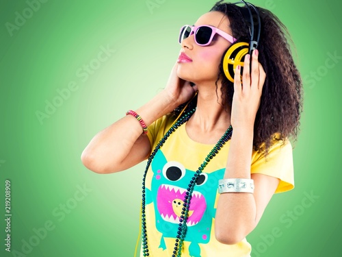 Beautiful disco african girl with headphones on background