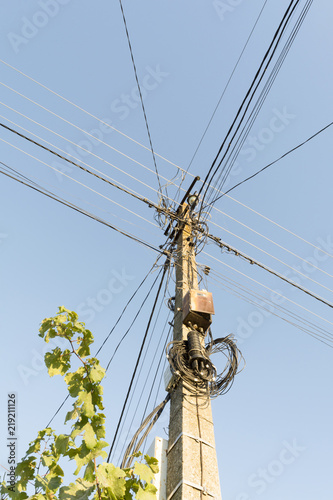 light support with a plurality of wires, optical coupling and switchboards mounted on a concrete pillar