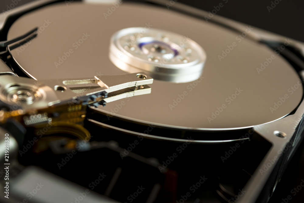 Computer hard drive opened up, showing the two disks and the needle inside and the blurred background. Computer hard drive opened up, showing the two disks and the needle inside and the blurred background.