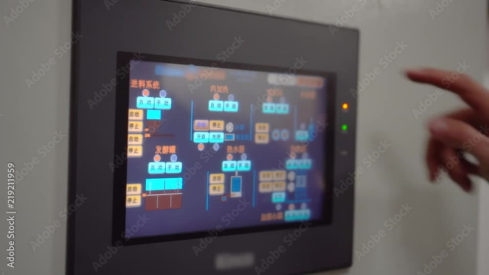 Man touches control panel on equipment box. Touchscreen interface on monitoring equipment. Industrial equipment screen for status and modification.
