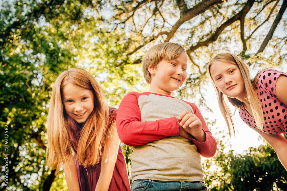 Group of 3 funny kids playing together outside on a sunny day. Two girls  and little boy having fun in the park Stock Photo | Adobe Stock