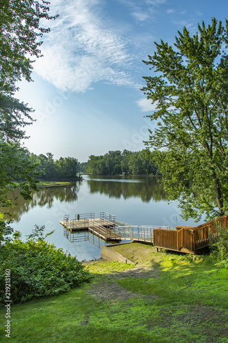 Dock on a river on a summer morning with blue sky © Luc Pouliot