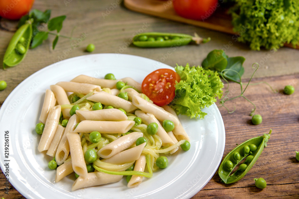 Penne pasta with green peas, zucchini noodle and herbs Penne pasta with green peas, zucchini noodle and herbs