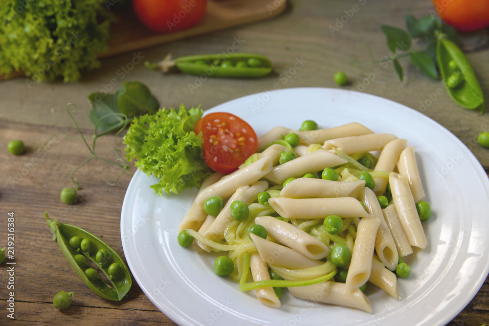 Penne pasta with green peas, zucchini noodle and herbs Penne pasta with green peas, zucchini noodle and herbs