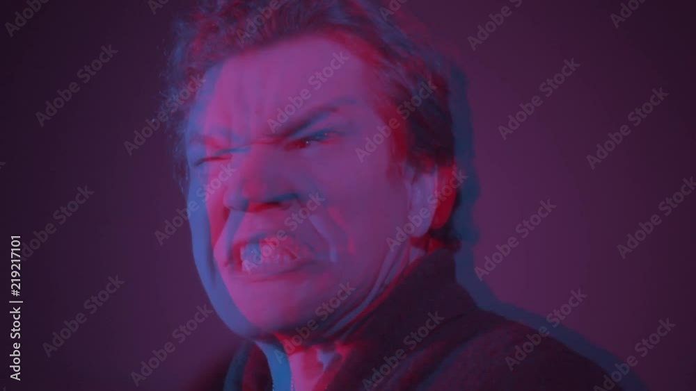 Glitchy noisy video of screaming man. Screaming slow motion man distorted with interference and digital noise. Slowmo intense emotion causing signal distortion and degradation. Glitchy noisy video of screaming man. Screaming slow motion man distorted with interference and digital noise. Slowmo intense emotion causing signal distortion and degradation.
