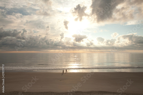 Two People Walking at Sunrise