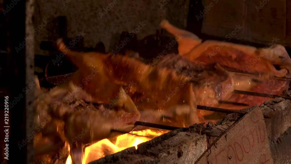 VIENTIANE,  LAOS - CIRCA AUGUST 2018 : WHOLE CHICKEN and DUCK grilled on fire at the street food shop in BAN ANOU NIGHT MARKET.