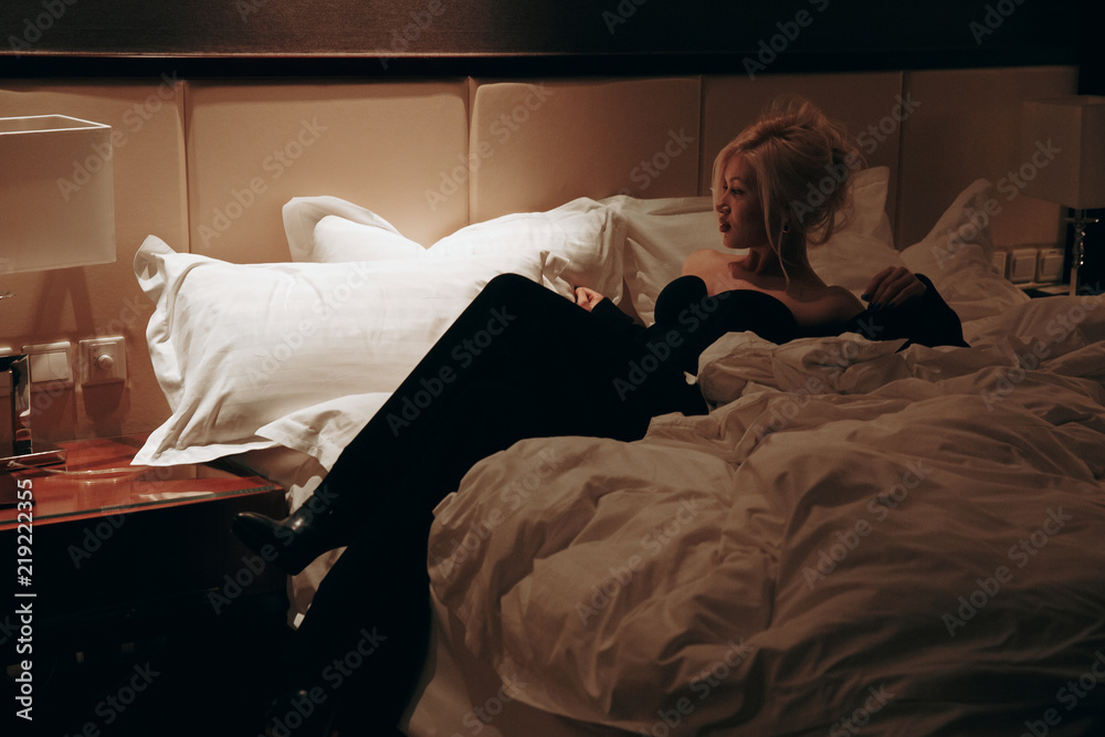Sexy girl in black in bed.Blonde in bed