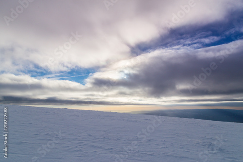 Winter alpine scenery with fresh snow, mist, and beautiful evening light