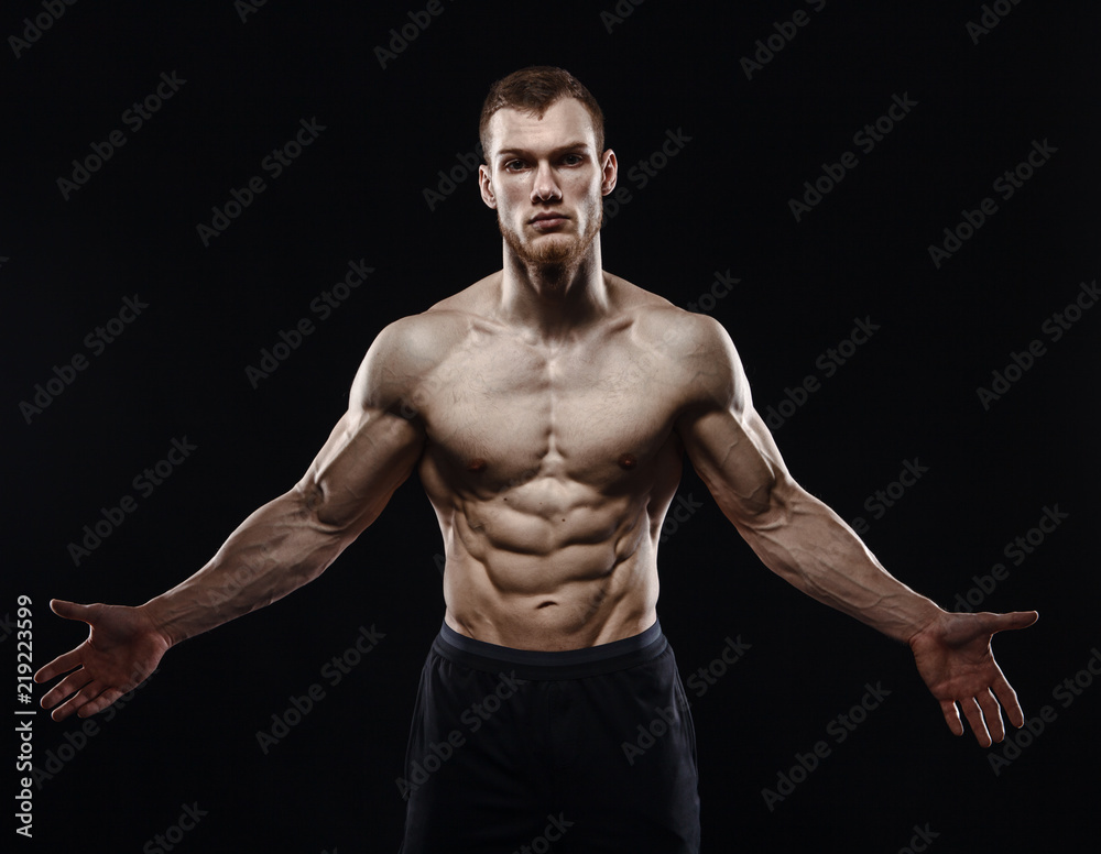 Aggressive man is a fighter, a bodybuilder on a black Aggressive man is a fighter, a bodybuilder on a black
