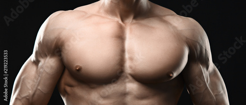 Perfect muscular male torso on black background photo