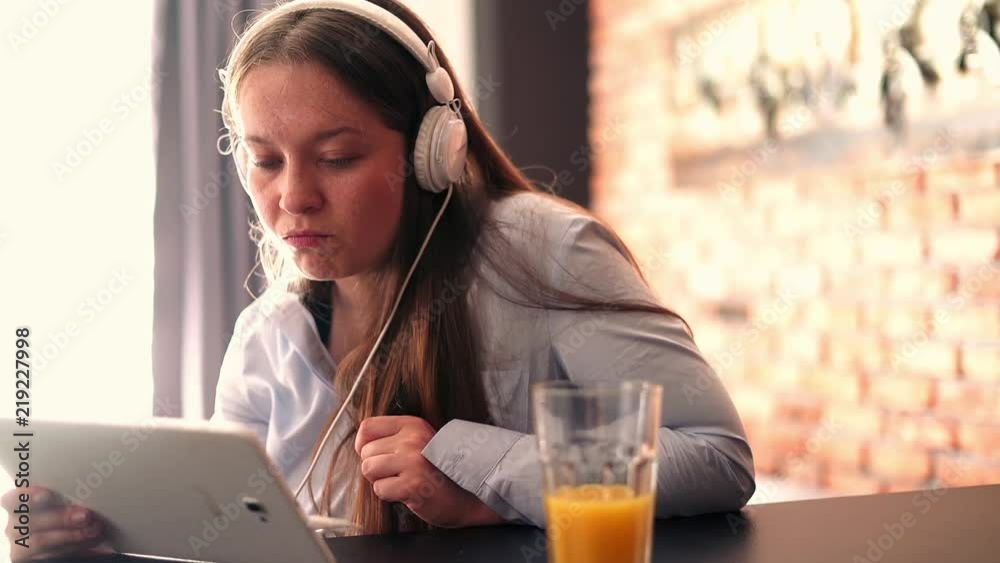Young cute woman watching movie by table at home
Young cute woman watching movie by table at home