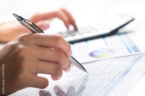 Close-up of a Businessman Analyzing Business Graphs with © BillionPhotos.com
