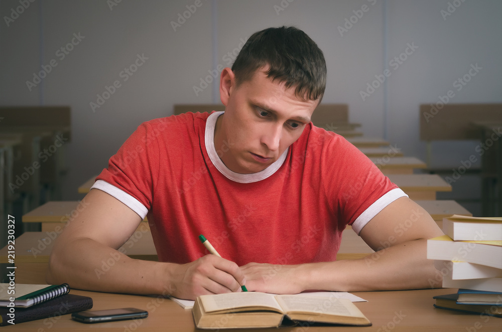 Serious student hides a cheat sheet and writes off a test work. Serious student hides a cheat sheet and writes off a test work.