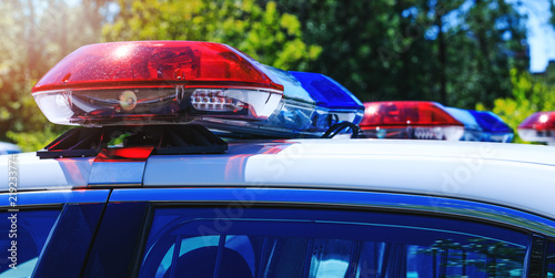 Patrol police car with beautiful emergency sirens lights. Canadian policemen in traffic control activity. A police raid for arrest and stop of crime delinquents. Flashing light on the cars.