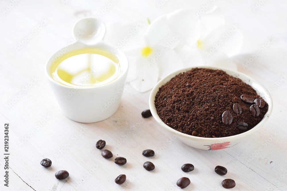 coffee scrub and oil with plumeria flower on white wood background, spa concept,top view,flat lay coffee scrub and oil with plumeria flower on white wood background, spa concept,top view,flat lay