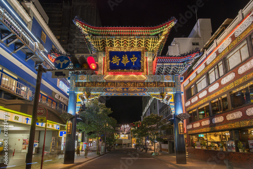 Large blue Chinese portal through which the sun rises whose protective animal is the blue dragon and which marks the eastern entrance to the Yokohama china town in Japan.